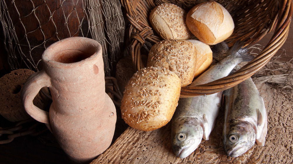medieval bread with fish, wine jug