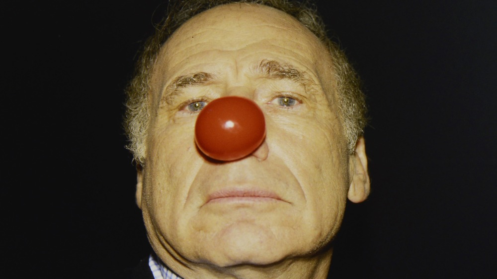 Mel Brooks wears a red nose 