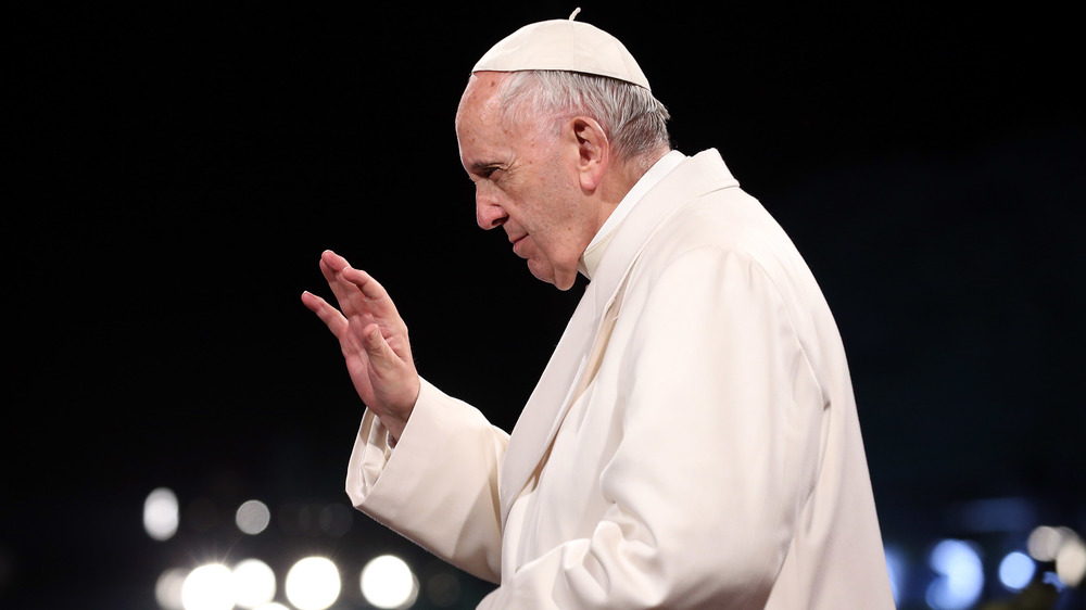 Pope Francis raising his hand