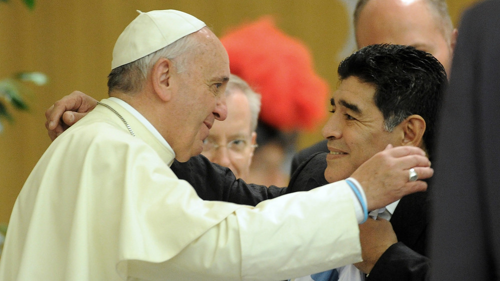 Pope Francis and Diego Maradona about to hug