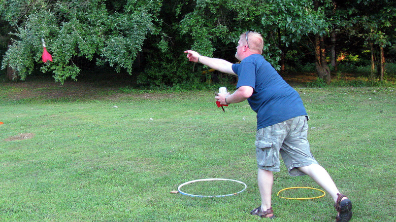 Man throws lawn darts