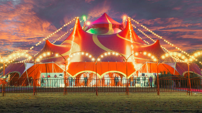 A brightly lit circus tent 