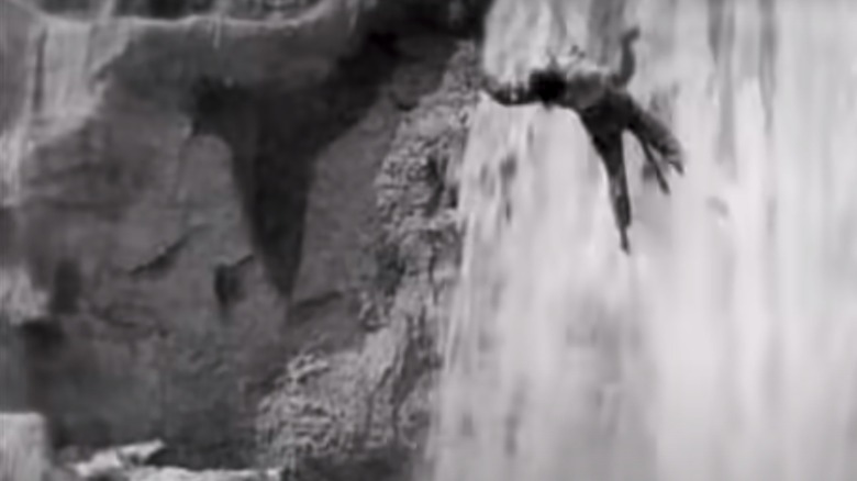 Keaton hangs beneath a waterfall