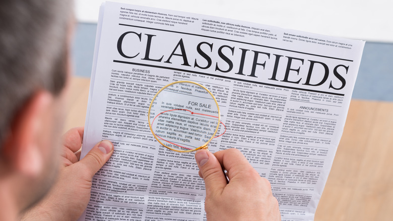 Man looking at classified ads
