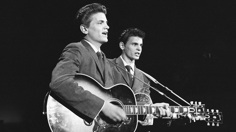 The Everly Brothers playing guitars in 1957