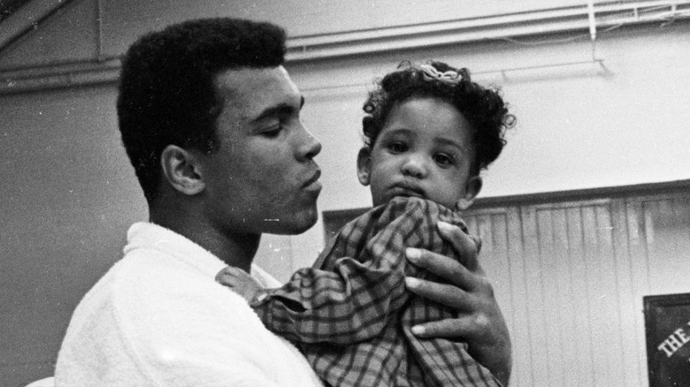 Muhammad Ali  holding a child